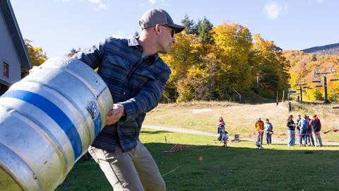 A man throwing a keg at Oktoberfest