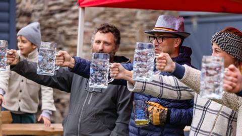 A group struggling to hold steins