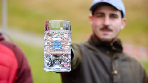 A man struggling to hold a stein