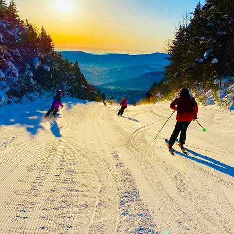 Skiing a groomer during a sunrise. 