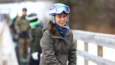 A beginner skier or rider smiling while riding the Welcome Mat