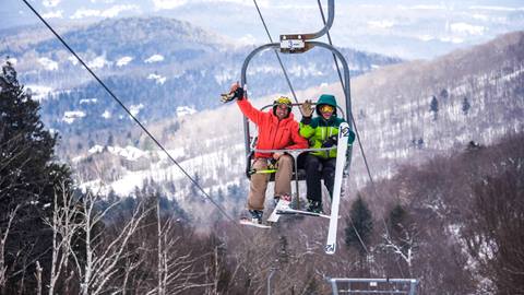 Friends waving from Castlerock Double Chair