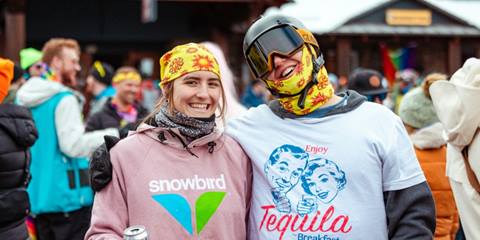 Two friends smiling and posing together during a winter event at Sugarbush.