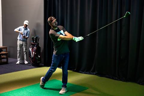 Golf lesson at an indoor golf simulator