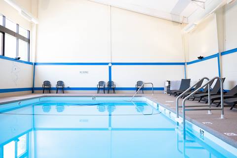 indoor pool with lounge chairs surrounding it