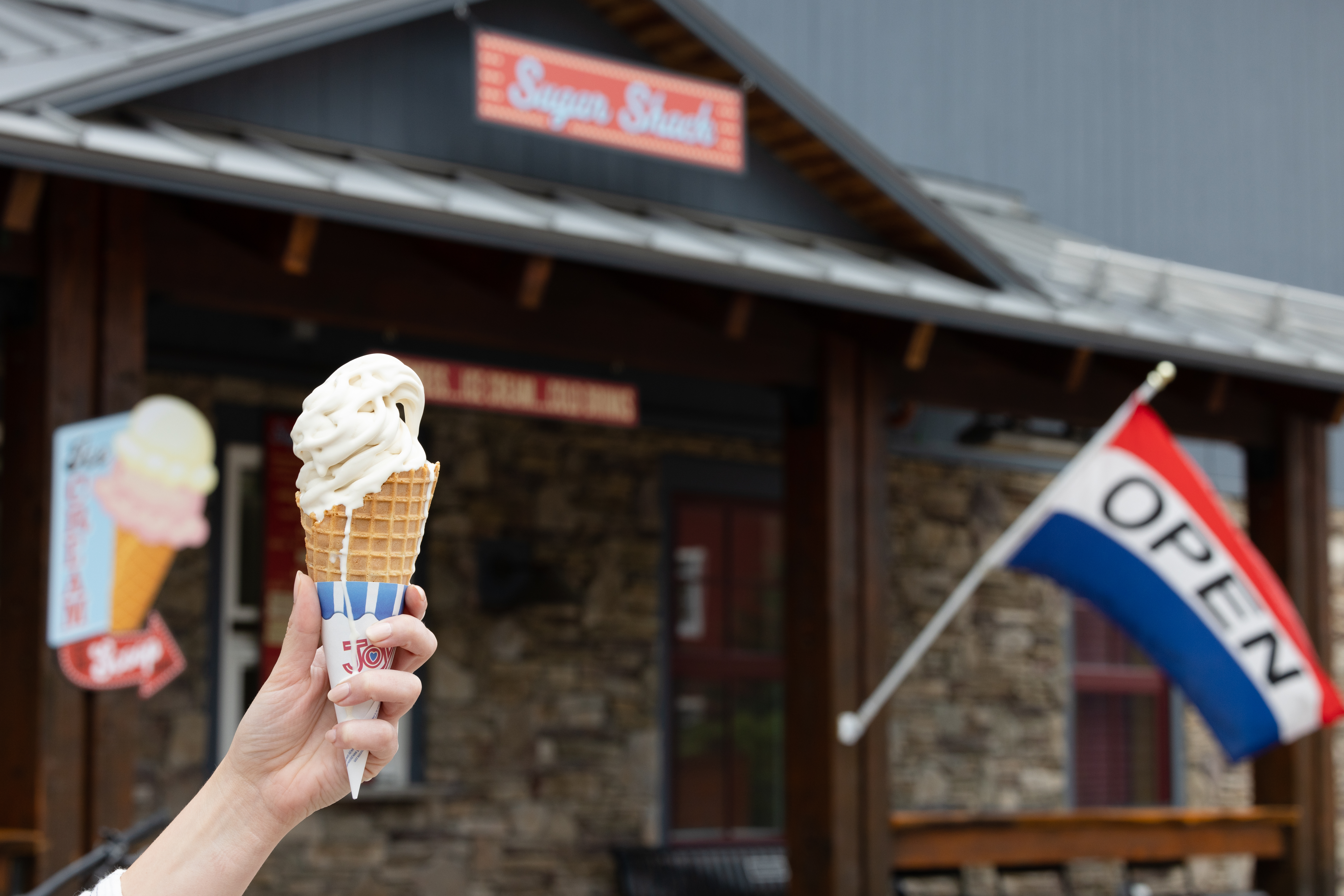 maple creemee in front of sugar shack sign
