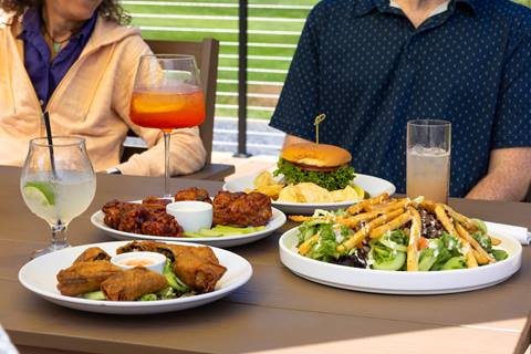 Wings, egg rolls, and a salad on the deck of The Clubhouse
