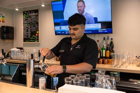 A bartender pouring a drink at The Clubhouse