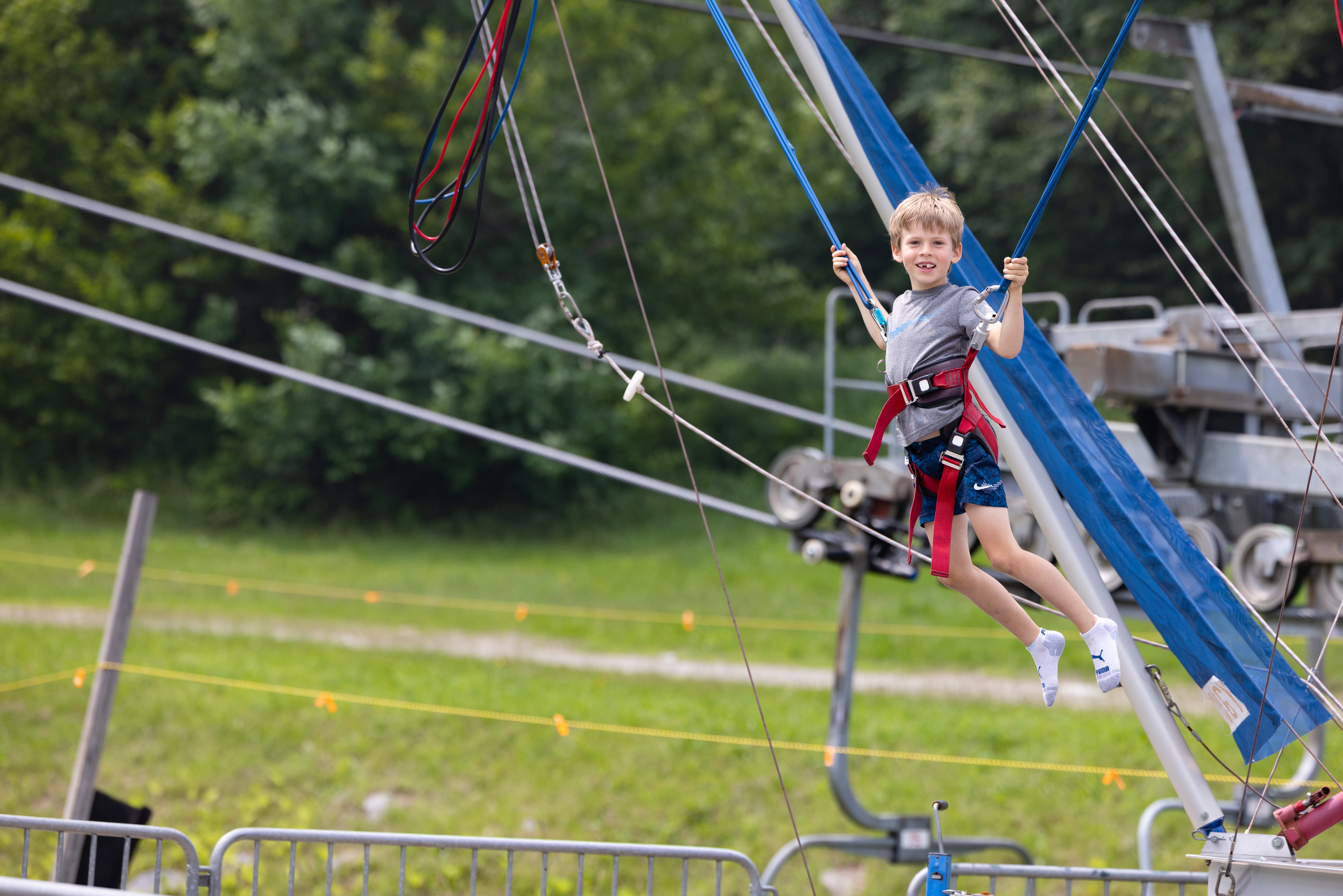 kid smiling while jumping on bungee trampoline