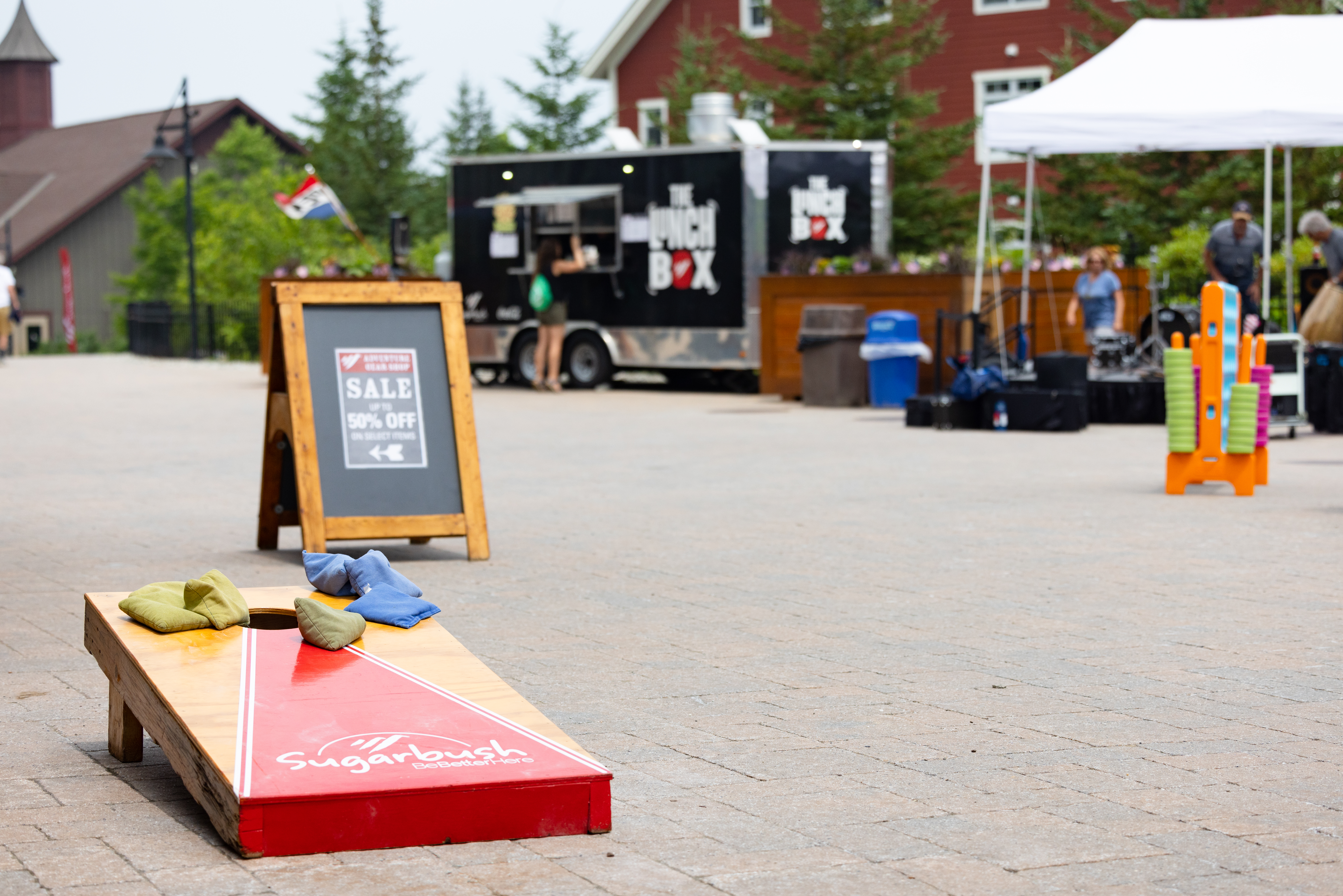 close up of cornhole board with food truck in background