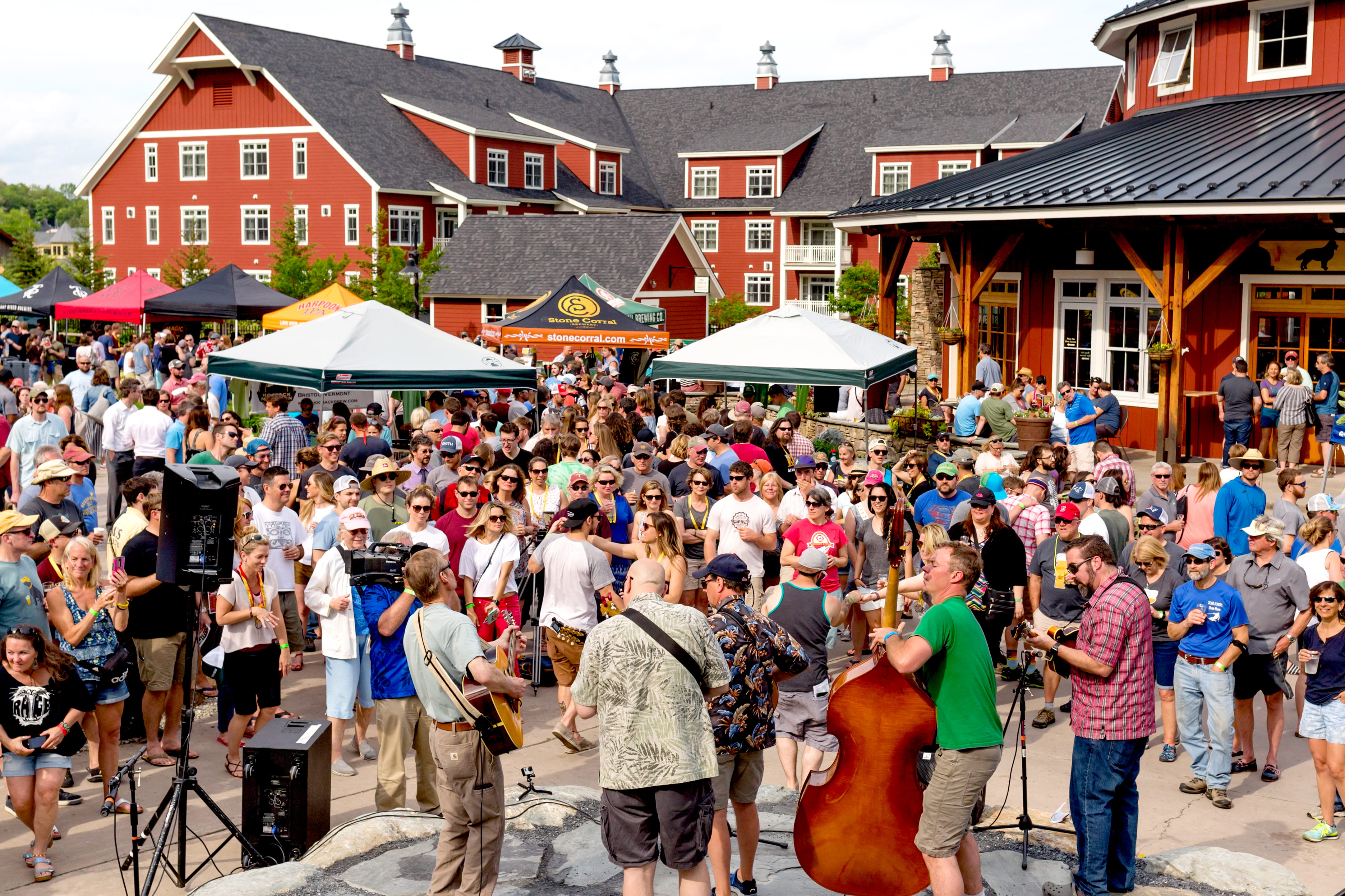crowd around live band playing in courtyard