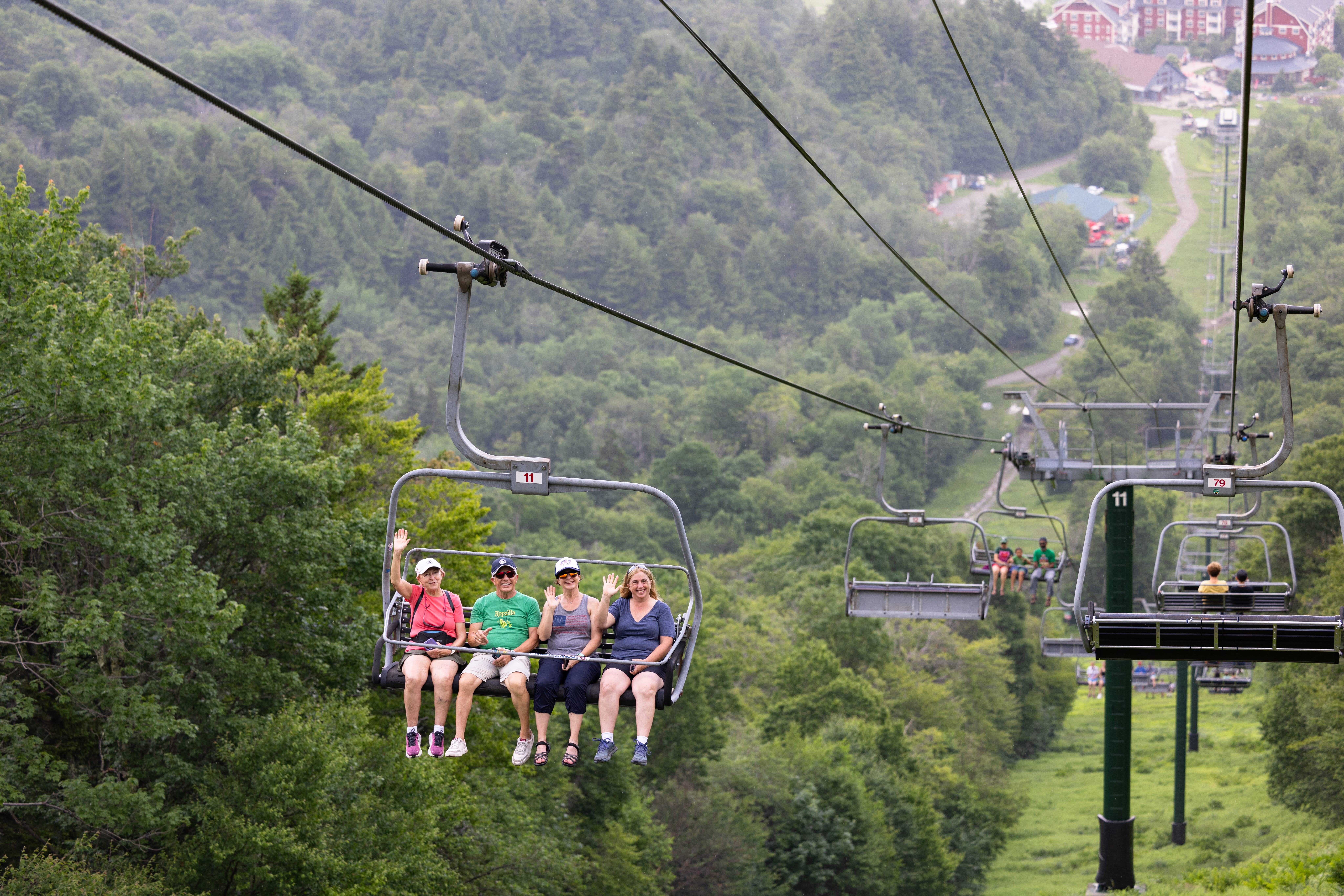 people waving on scenic lift ride