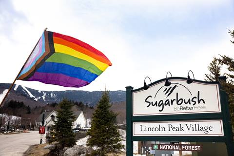 Pride flag flying near Sugarbush welcome sign