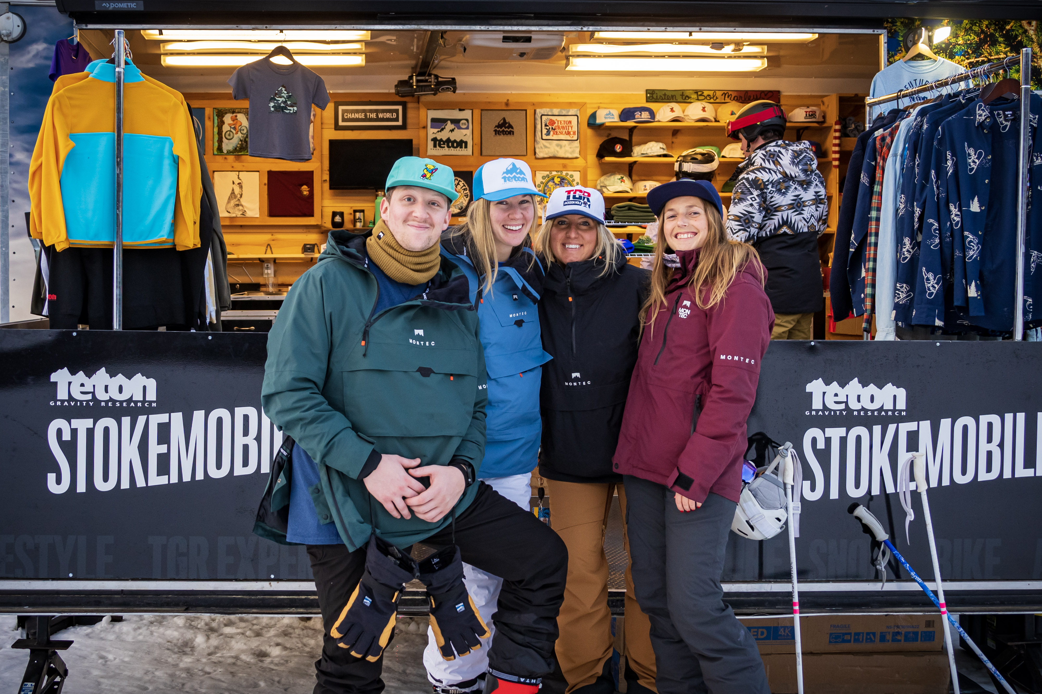 Group of people posing in front of teton booth