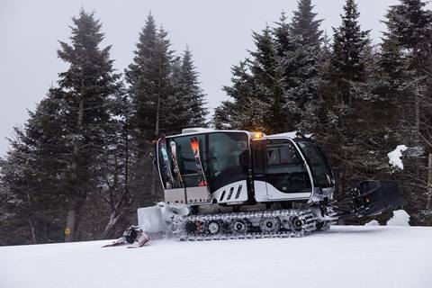 Exterior shot of a snowcat on a ski trail