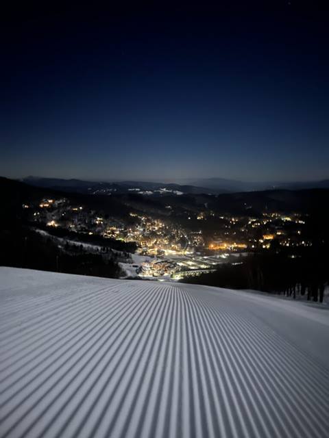 Close up of a groom trail with Sugarush Resort in the background at night
