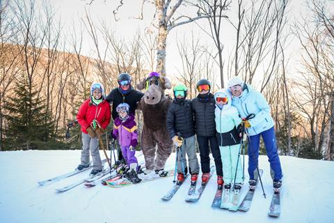 Group of skiers on a snowy ski trail 