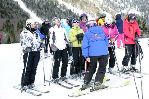 Group of skiers on a snowy ski trail 