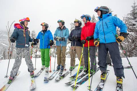 Group of skiers on a snowy ski trail