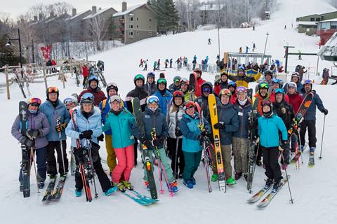 Group of skiers on a snowy ski trail