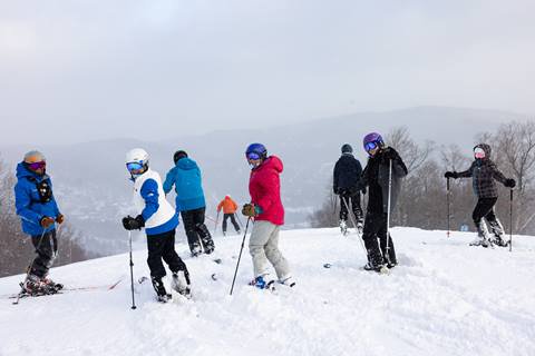 Group of skiers on a snowy ski trail