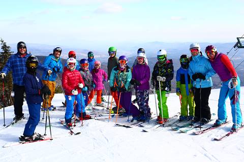 Group of skiers on a snowy ski trail