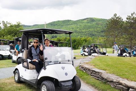 two women golfers driving in golf cart