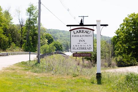 Close up of the Lareau Farm & Forrest Inn and American Flatbread Sign in the mad river valley