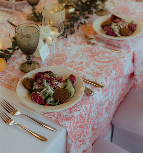 Plates of food on a table at a wedding