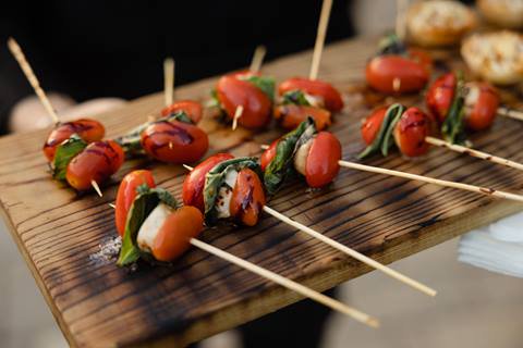 Meat and vegetable skewers on a serving board