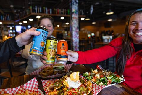 Group of people sharing a beer inside a restaurant