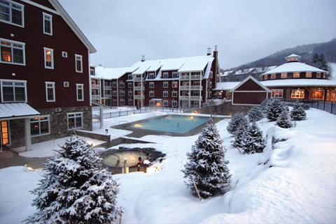 Exterior shot of the pool and hot tub area at Claybrook during winter