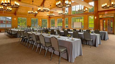 Tables set up for a business event in the Gate House Lodge 