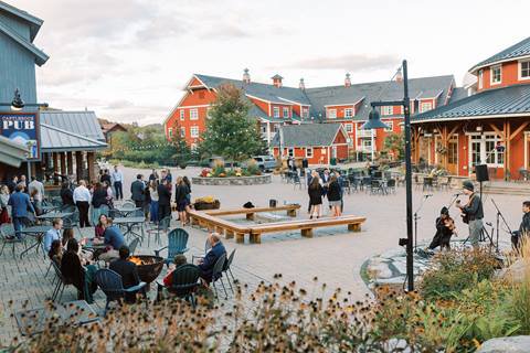 Groups of people outside the Gate House lodge enjoying the warm weather