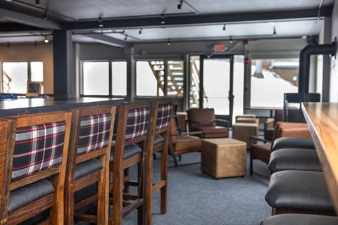 Seats and tables inside The Fifty8 at Sugarbush Resort