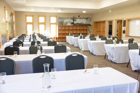 Tables set up for an event inside the Schoolhouse at Sugarbush Resort