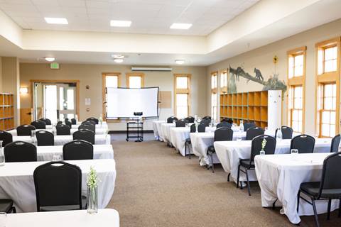 Tables set up for an event inside the Schoolhouse at Sugarbush Resort