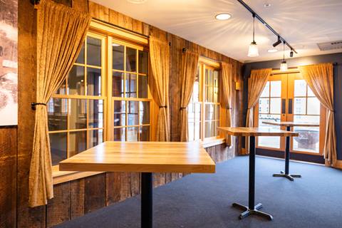 Tables and chairs set up in The Tucker at Sugarbush Resort
