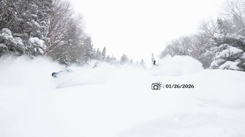 skiers and riders in tons of powdery snow