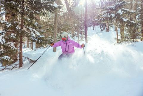 purple jacket powder skier