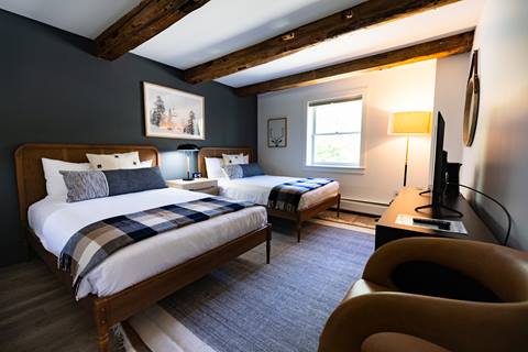 double bed hotel room with wood beams and modern finishes