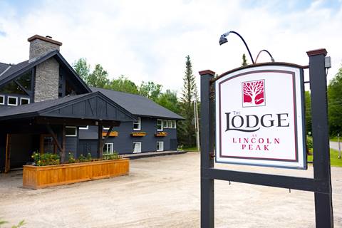 Lodge exterior with sign in parking lot