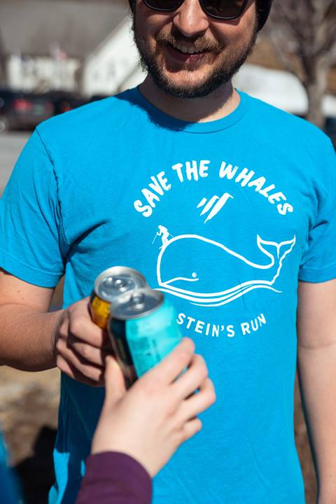 Man cheers beers in save the whales tee