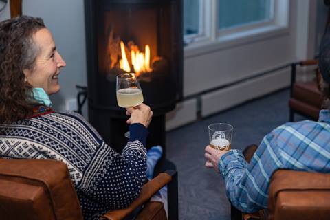 Drinking beverages by the fire in the Fifty8 Lounge