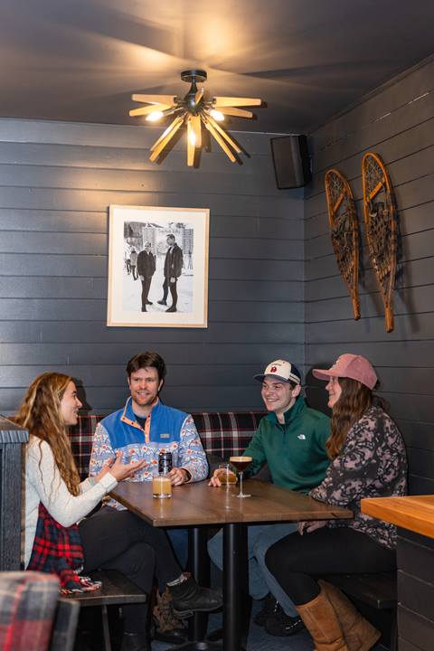 Friends sitting at a table at the Fifty8 Lounge