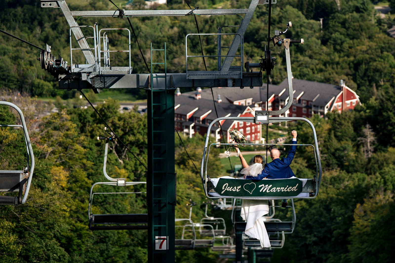 Bride and Groom Ride a Just Married decorated Chairlift after their mountaintop ceremony