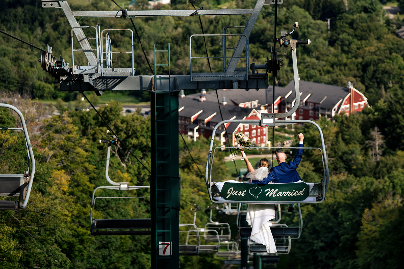Bride and Groom Ride a Just Married decorated Chairlift after their mountaintop ceremony