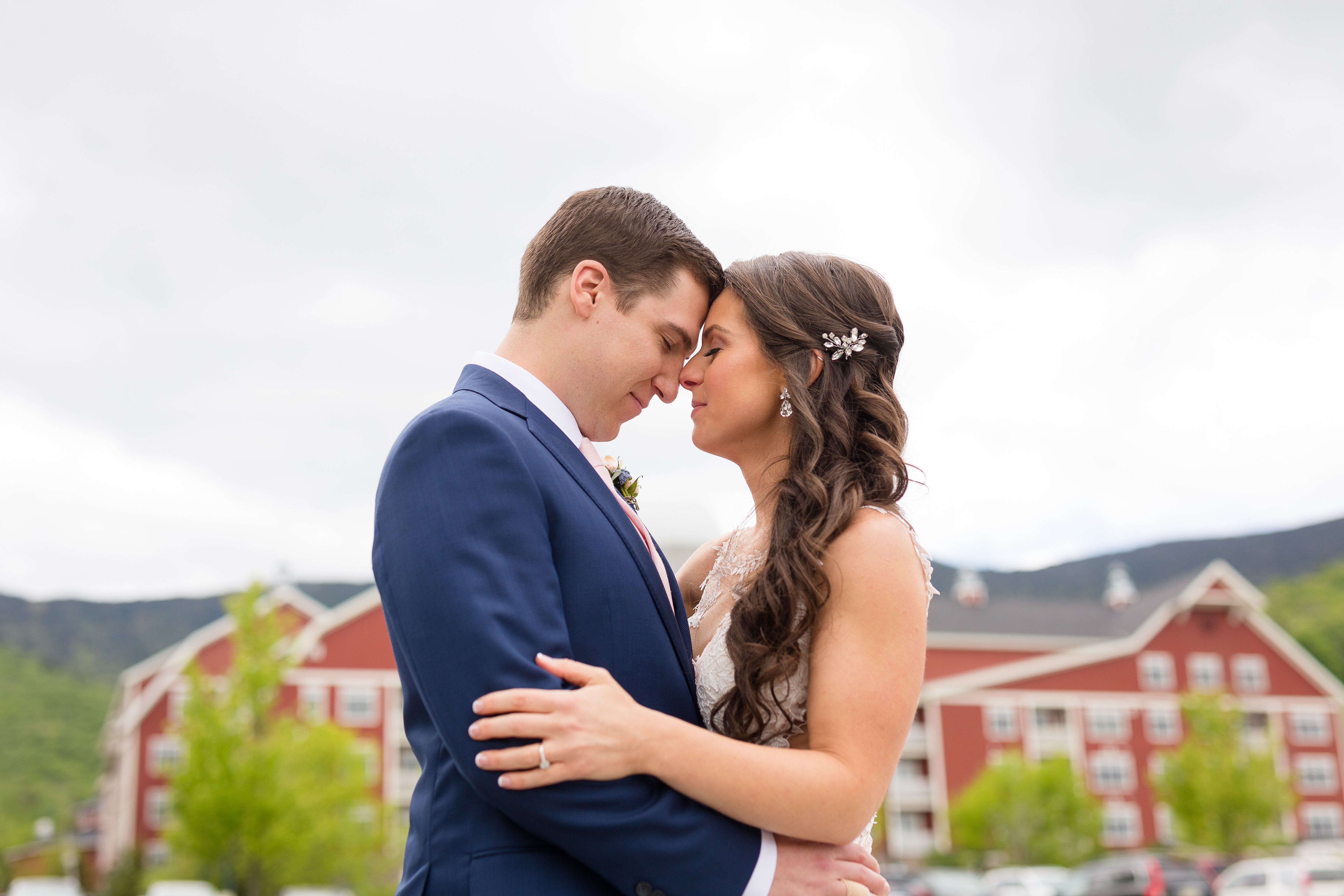 Bridge and Groom embrace Clay Brook Hotel in background