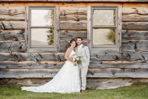 Formal Bride and Groom portrait in front of wooden building