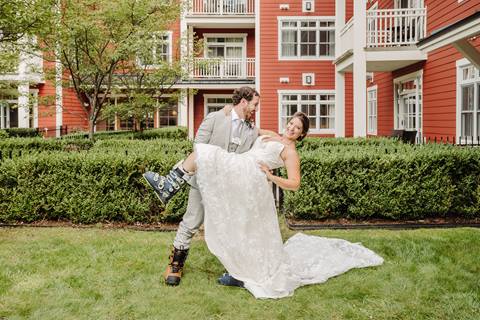 Bride and Groom pose for picture in front of Clay Brook Hotel